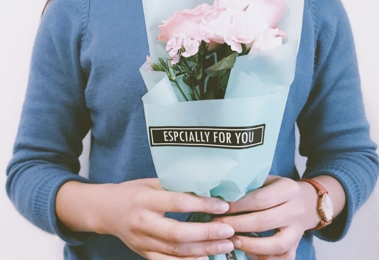 a person holding a bouquet of flowers in their hands.